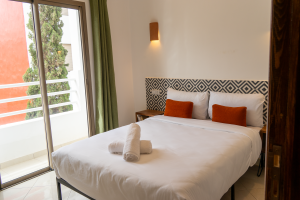 Premium double room with a private balcony, featuring a minimalist and refined decor at Les Terrasses Tamraght.