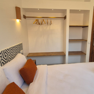 Classic double room les terrasses hostel tamraght Classic double room at Les Terrasses Hostel, Tamraght, featuring a comfortable double bed, warm terracotta lighting, and authentic Moroccan design touches for a premium stay.
