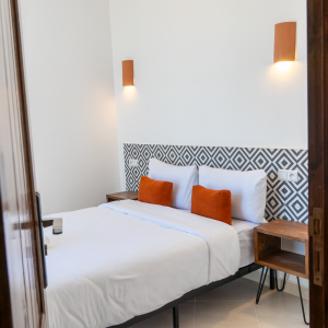 Ocean view double room balconny Les Terrasses Hostel Tamraght Morocco Premium double room with a private balcony overlooking Devil's Rock surf spot at Les Terrasses Hostel, Tamraght, perfect for checking the waves at sunrise.